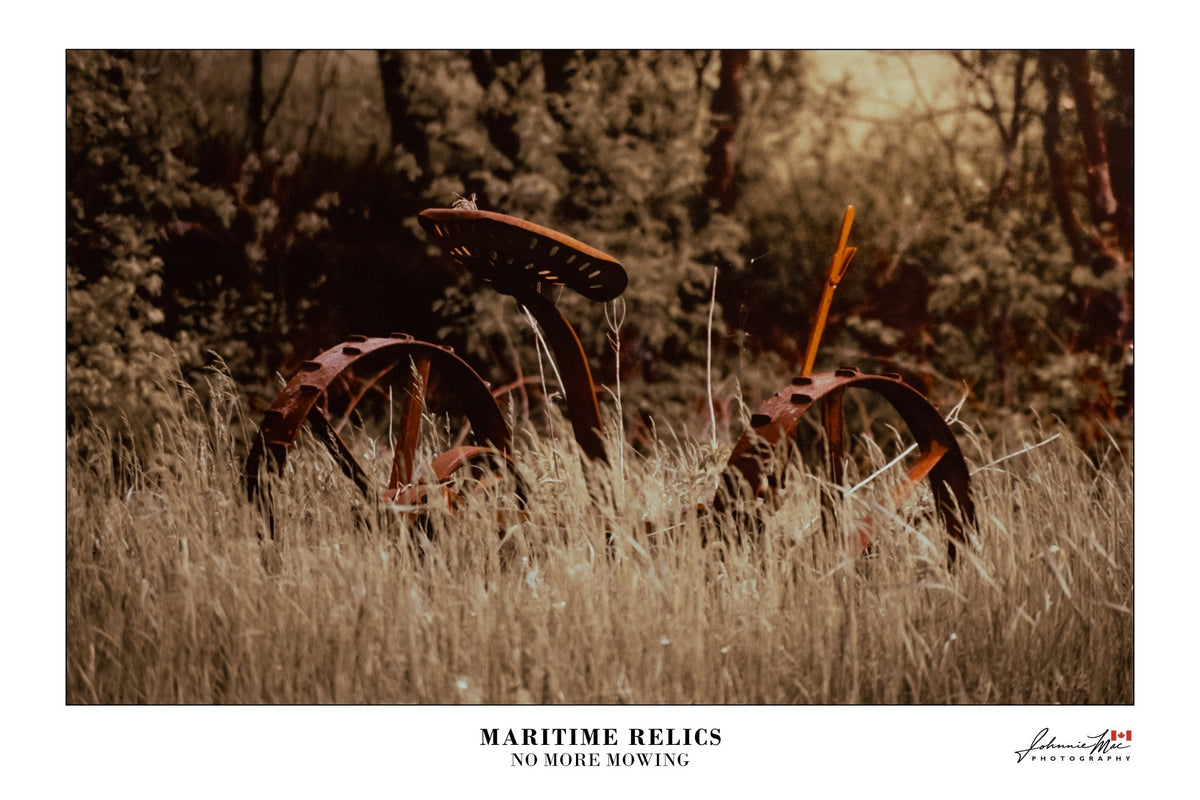 Maritime Relics, No More Mowing print: an old iron hay mower in tall, sun-faded grass, in warm sepia tones