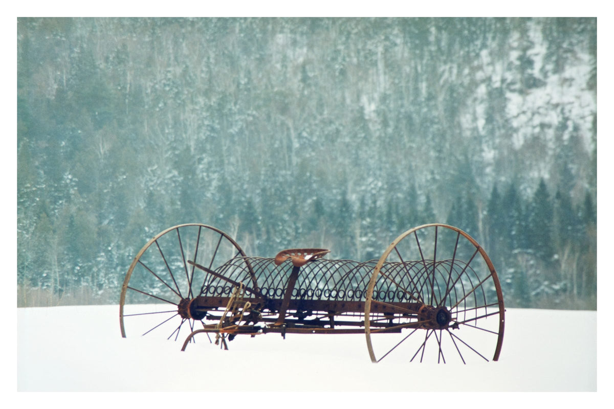 Retired Hay Rake, Gallery Edition print: an old iron hay rake standing in a snowy field