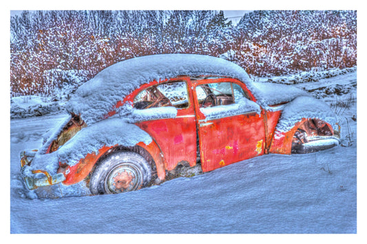Old red Volkswagen Beetle buried in fresh snow, rusted fenders against a cold blue winter scene — Winter Bugs Gallery Edition print with a white border